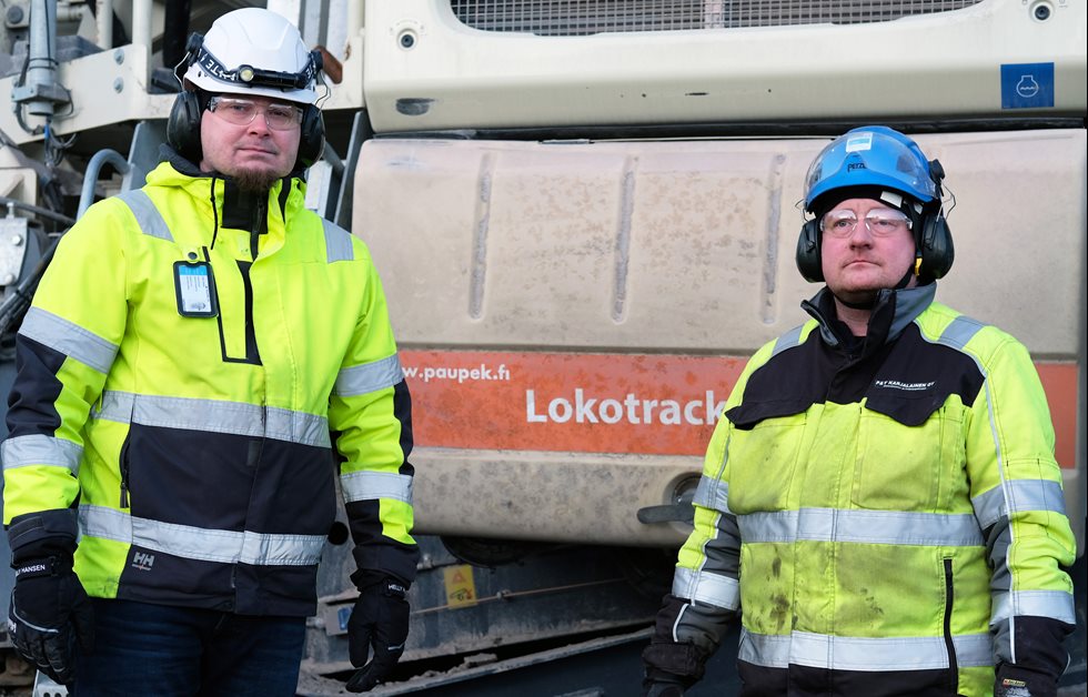 Two men standing in front of Lokotrack.