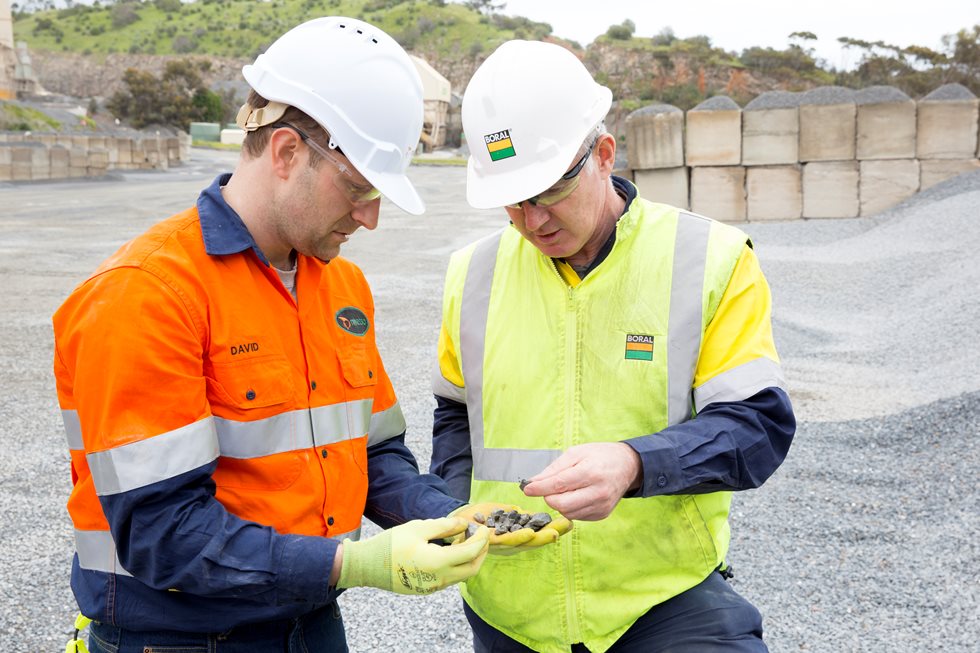 Two employees checking aggregate shape on the site