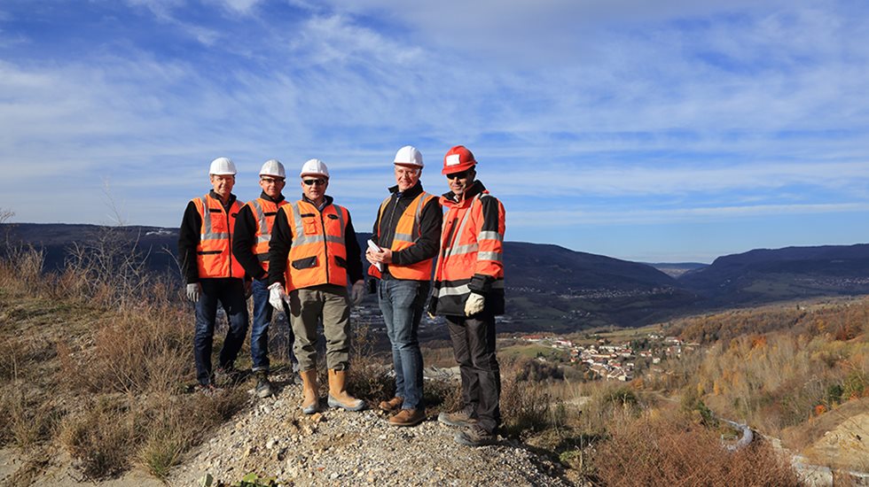 Group of people standing on a small hill at Famy's quarry in France.